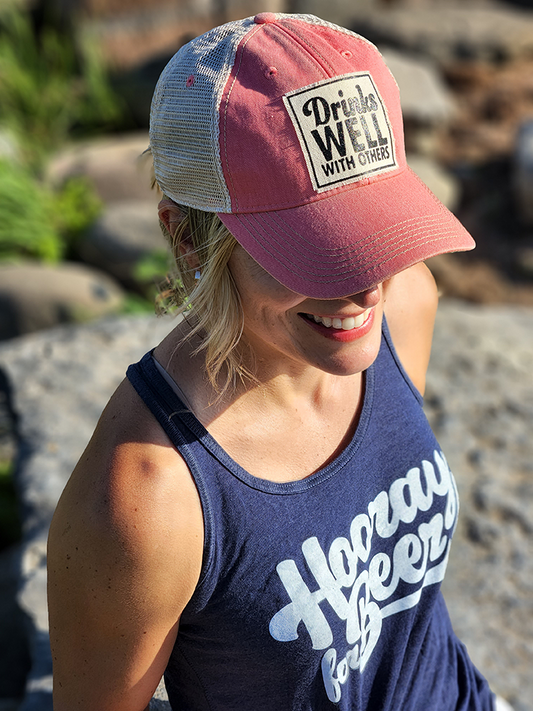 Vintage Distressed Trucker Cap - "Drinks Well with Others" - Pink These distressed beer hats are incredibly comfortable. Most trucker caps are rigid, but these vintage unstructured caps are made of a cotton/polyester blend with a soft mesh back that makes them fit more like a "Dad Hat." Now in Canada.
