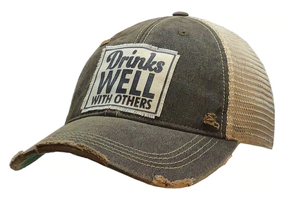 Vintage Distressed Trucker Cap - "Drinks Well with Others"  These distressed beer hats are incredibly comfortable.  Most trucker caps are rigid, but these vintage unstructured caps are made of a cotton/polyester blend with a soft mesh back that makes them fit more like a "Dad Hat." Now in Canada.